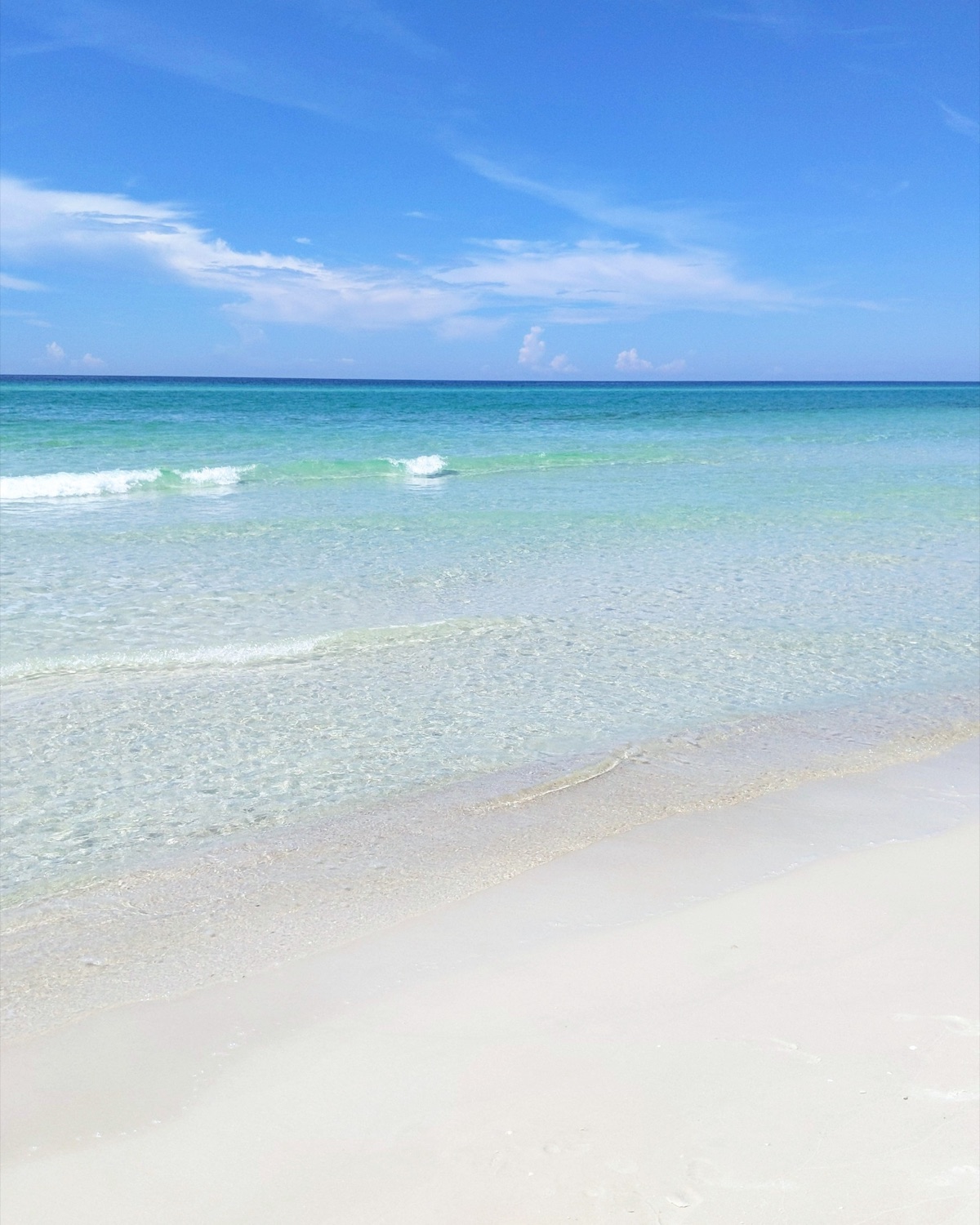 The clear turquoise water and white sand of Alys Beach on 30A