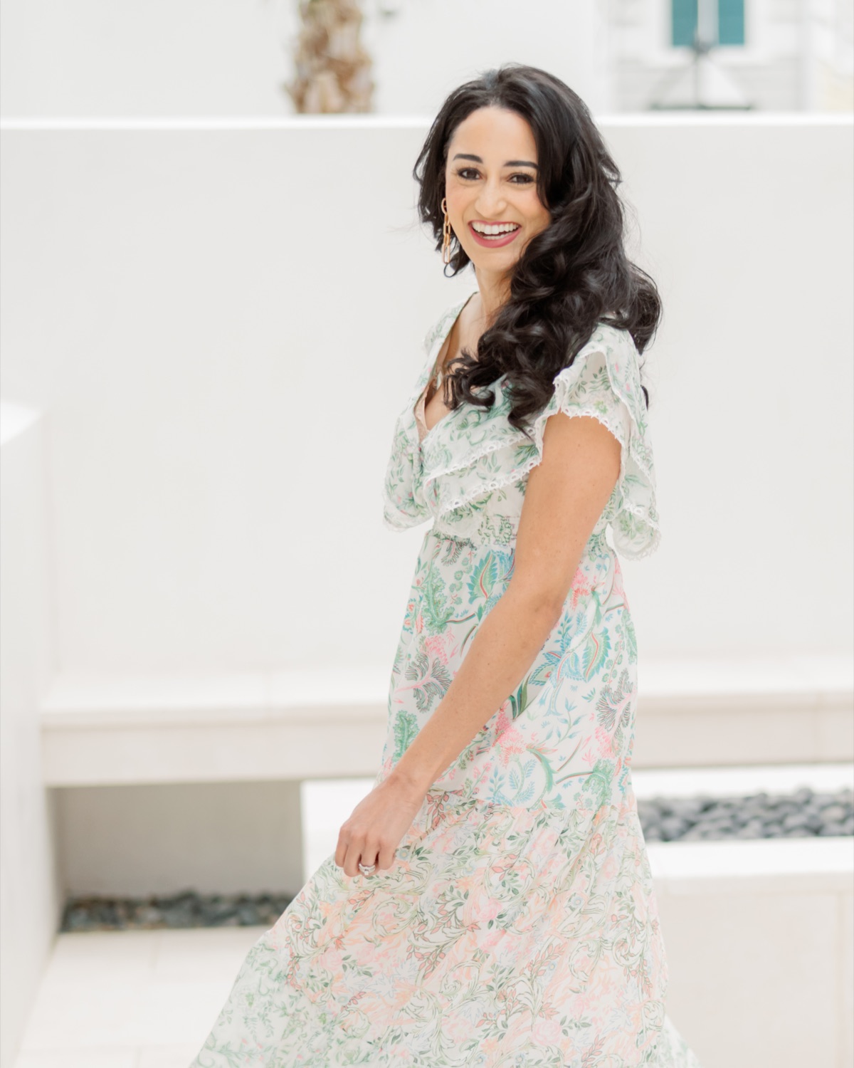 Macie in a floral dress at the Alys Beach retreat house