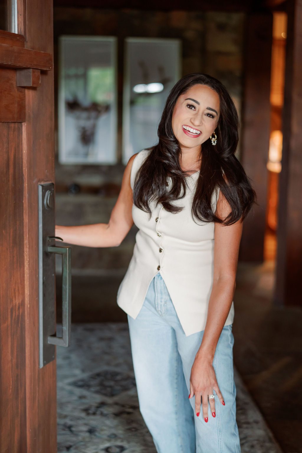 Macie Renae smiling in a doorway, welcoming you in